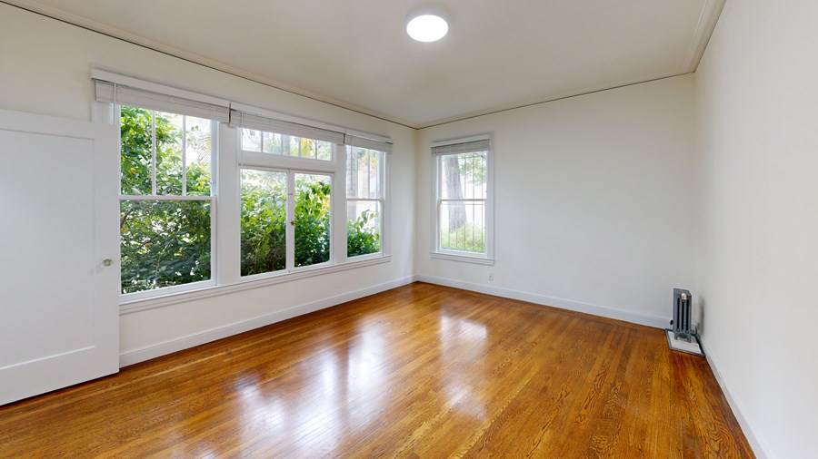 A room with wooden floors and white walls.